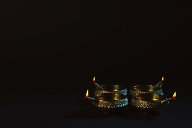 Diwali diyas or clay lamps on dark background