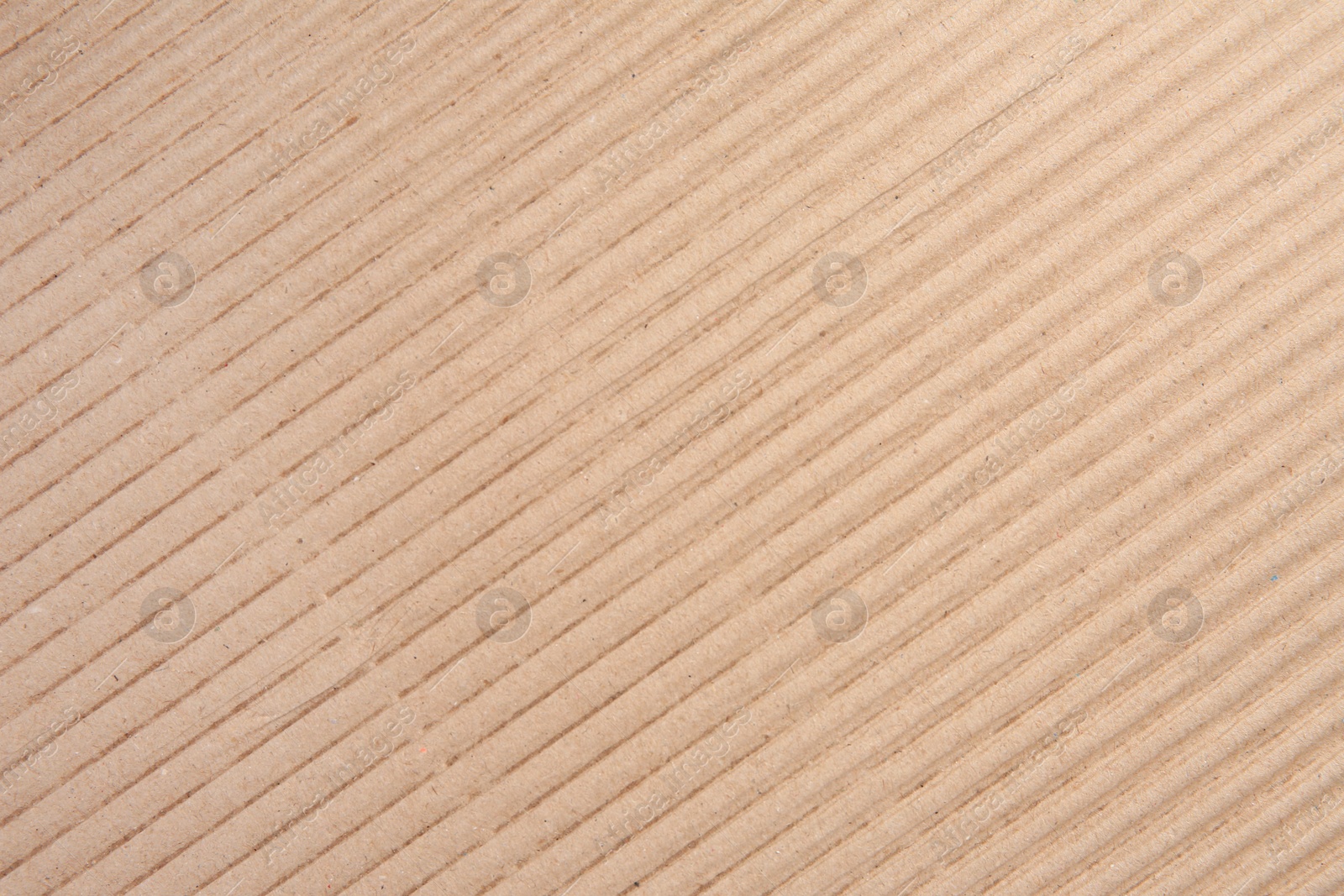 Photo of Texture of beige corrugated paper sheet as background, closeup