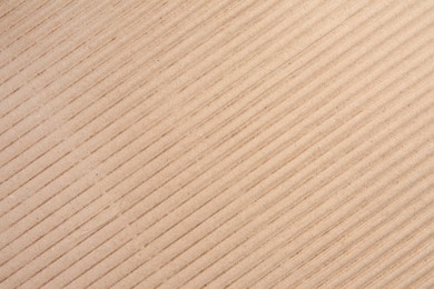 Texture of beige corrugated paper sheet as background, closeup