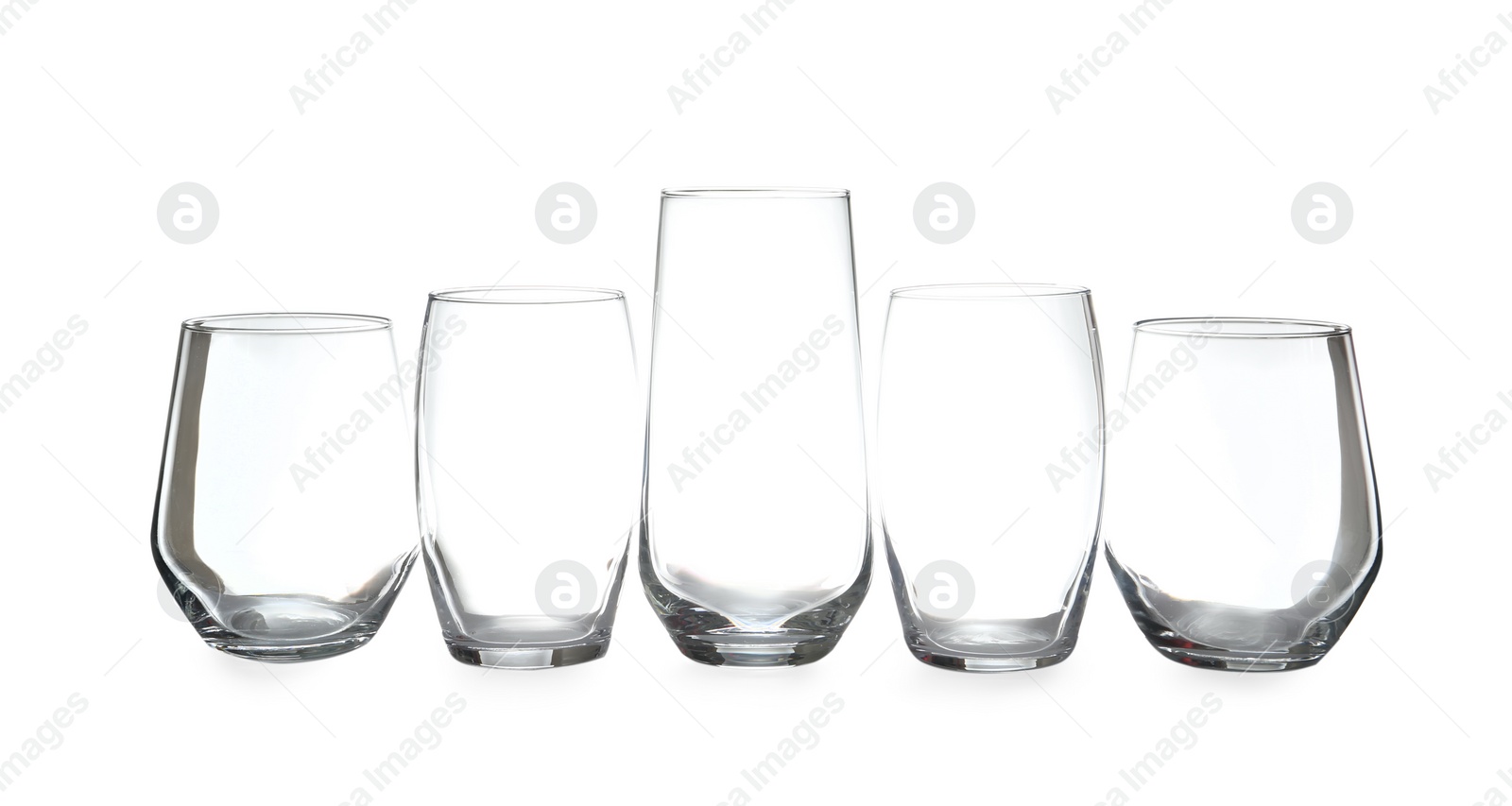 Photo of Set of different clean empty glasses isolated on white