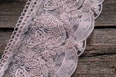 Photo of Beautiful lace on wooden table, top view