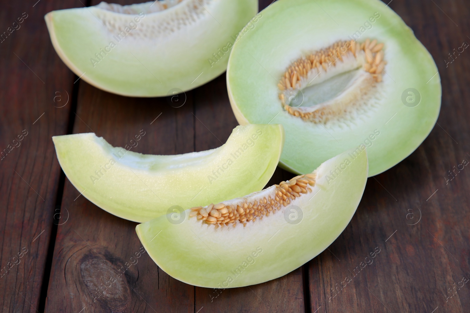 Photo of Cut tasty ripe melon on wooden table