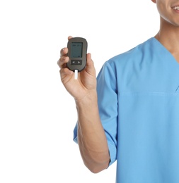 Male doctor holding glucose meter on white background, closeup. Medical object