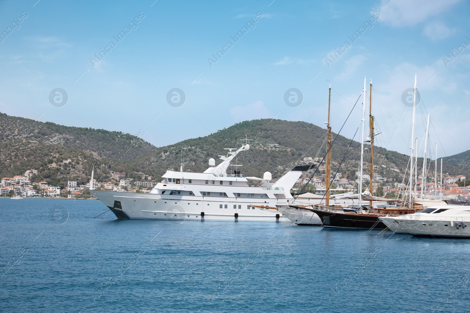 Photo of Beautiful view of different boats in sea near shore on sunny day