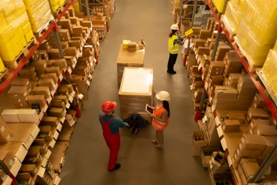 Image of Manager and workers at warehouse, above view. Logistics center