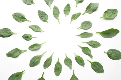 Frame made of fresh green healthy spinach leaves on white background, above view