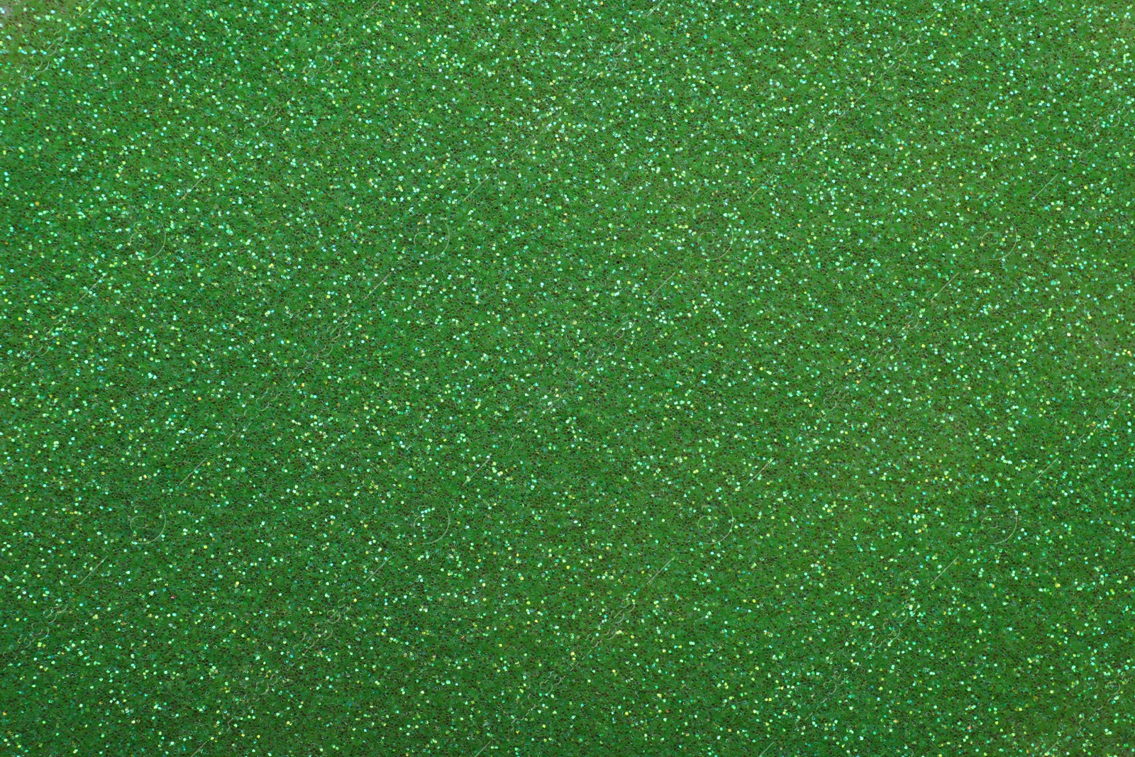 Photo of Beautiful shiny green glitter as background, closeup