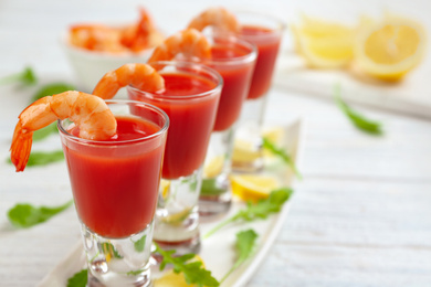 Photo of Shrimp cocktail with tomato sauce on table, closeup. Space for text