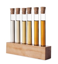 Photo of Test tubes with brown liquid in stand on white background