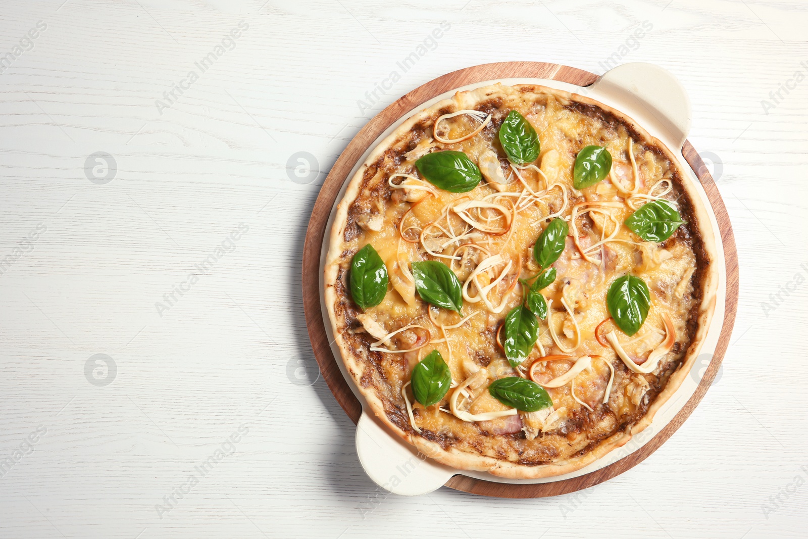 Photo of Board with delicious homemade pizza and space for text on wooden background, top view