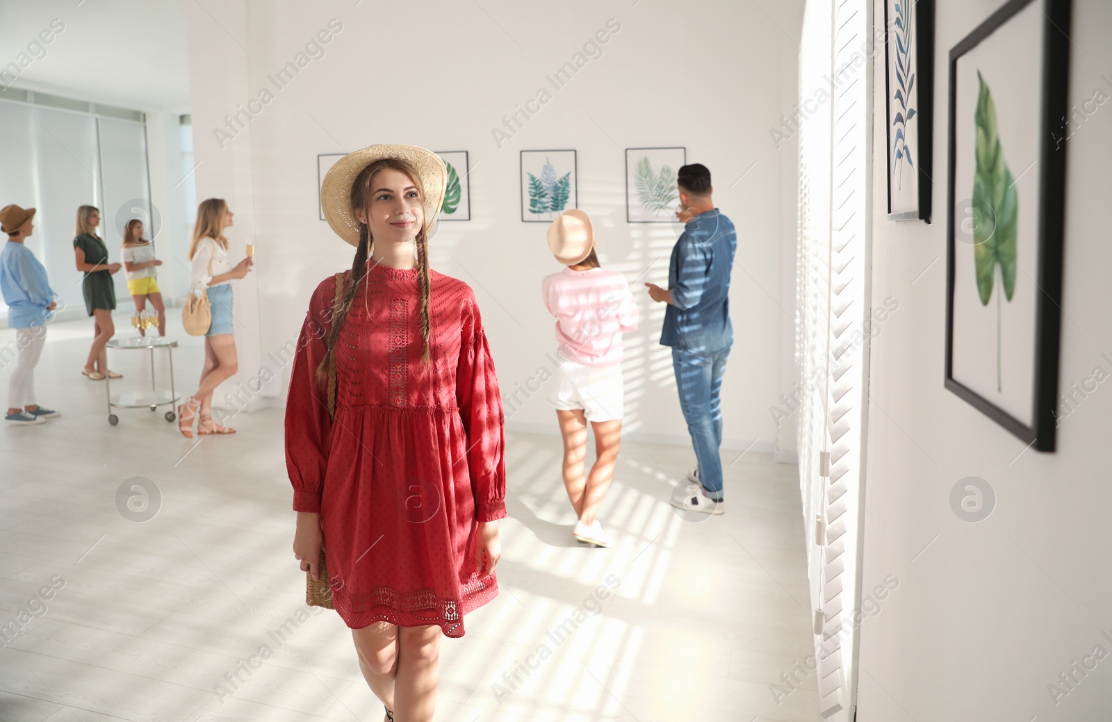 Photo of Young woman at exhibition in art gallery