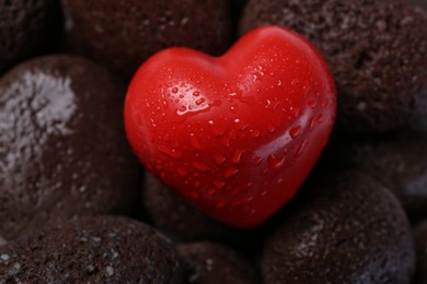 Photo of Red decorative heart on stones, closeup view