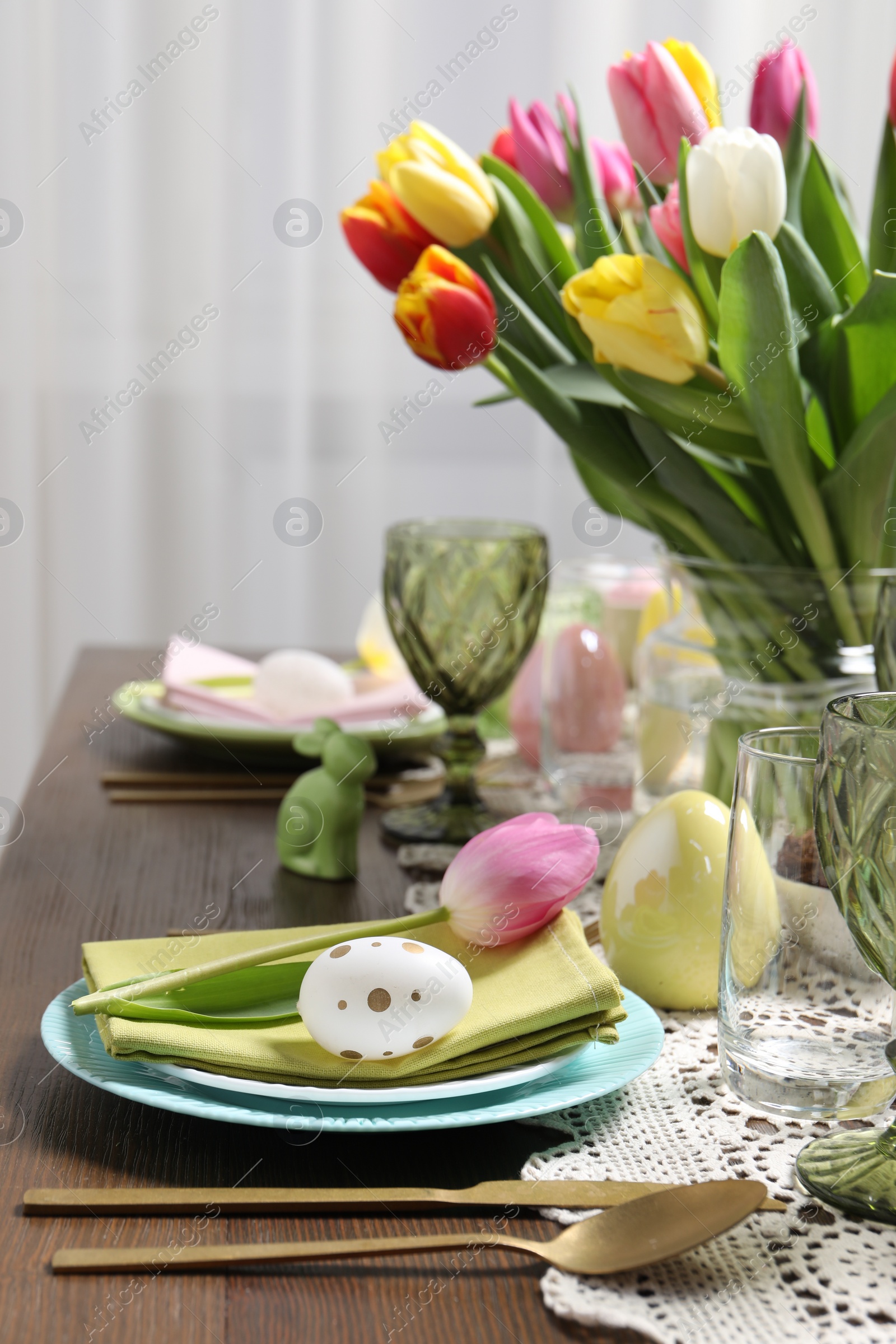 Photo of Festive table setting with beautiful flowers. Easter celebration