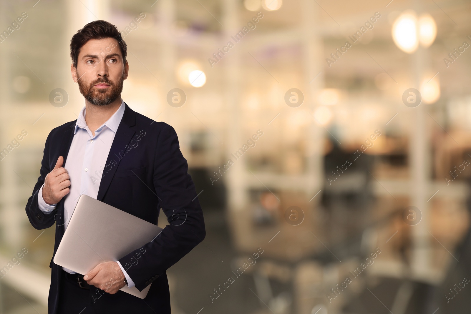 Image of Successful lawyer with laptop on blurred background, space for text