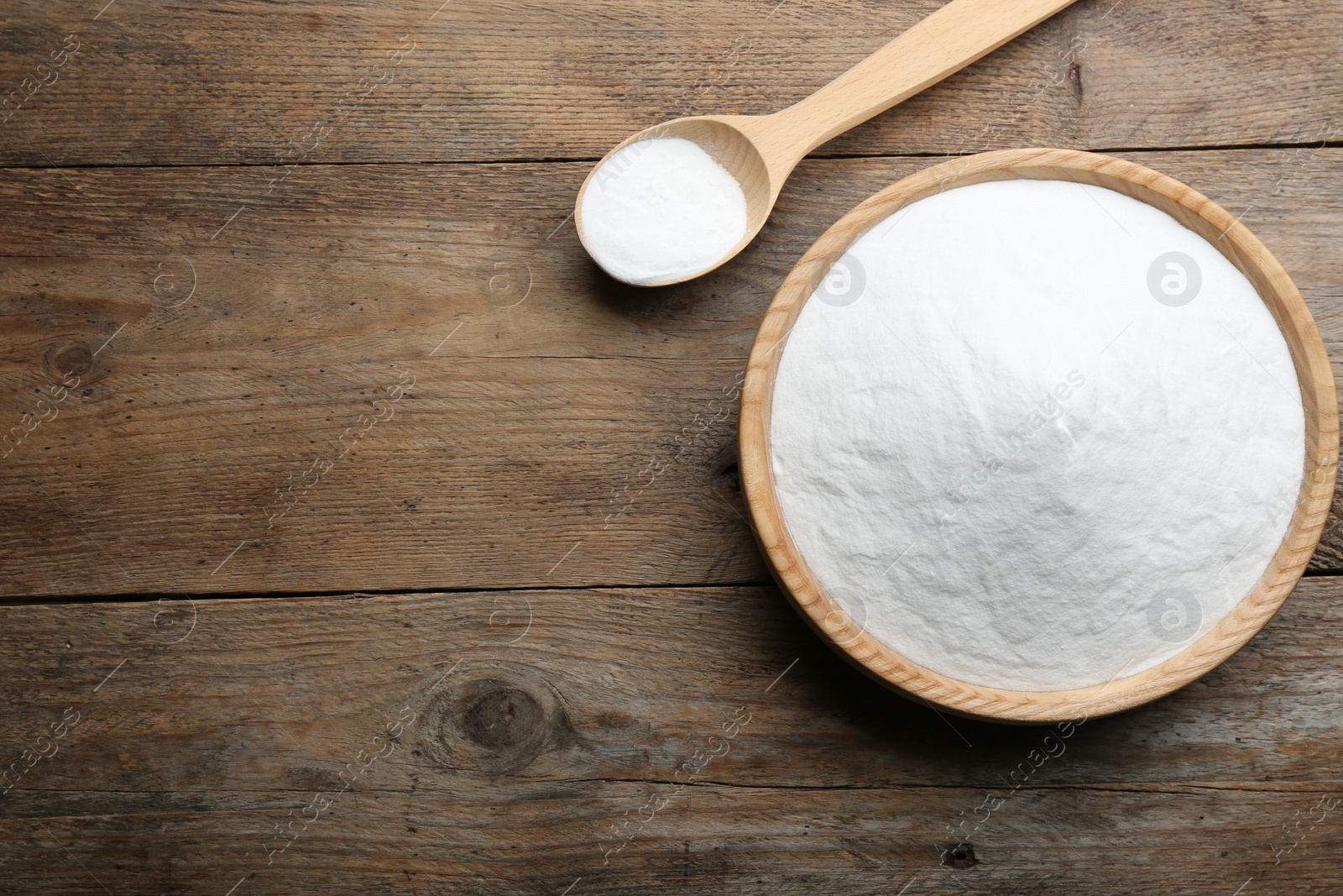 Photo of Baking soda on wooden table, flat lay. Space for text