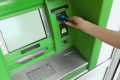 Photo of Mature woman using cash machine for money withdrawal, closeup