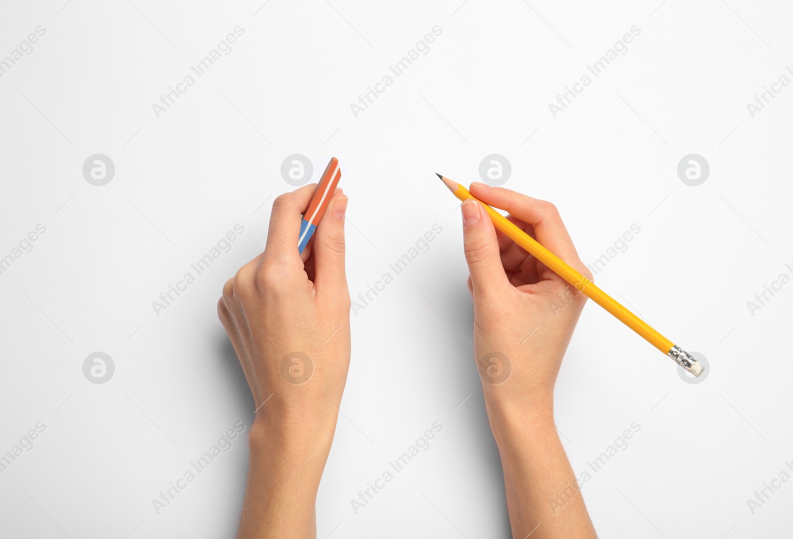 Photo of Woman with graphite pencil and eraser on white background, top view