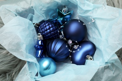 Photo of Beautiful Christmas baubles in box on faux fur