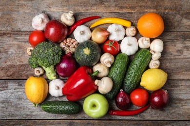 Photo of Ripe fruits and vegetables on wooden table, flat lay
