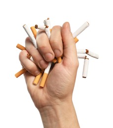 Photo of Stop smoking. Man holding broken cigarettes on white background, closeup