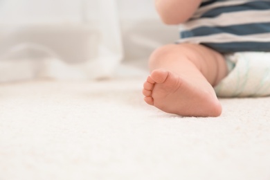 Cute little baby on carpet indoors, closeup with space for text. Crawling time