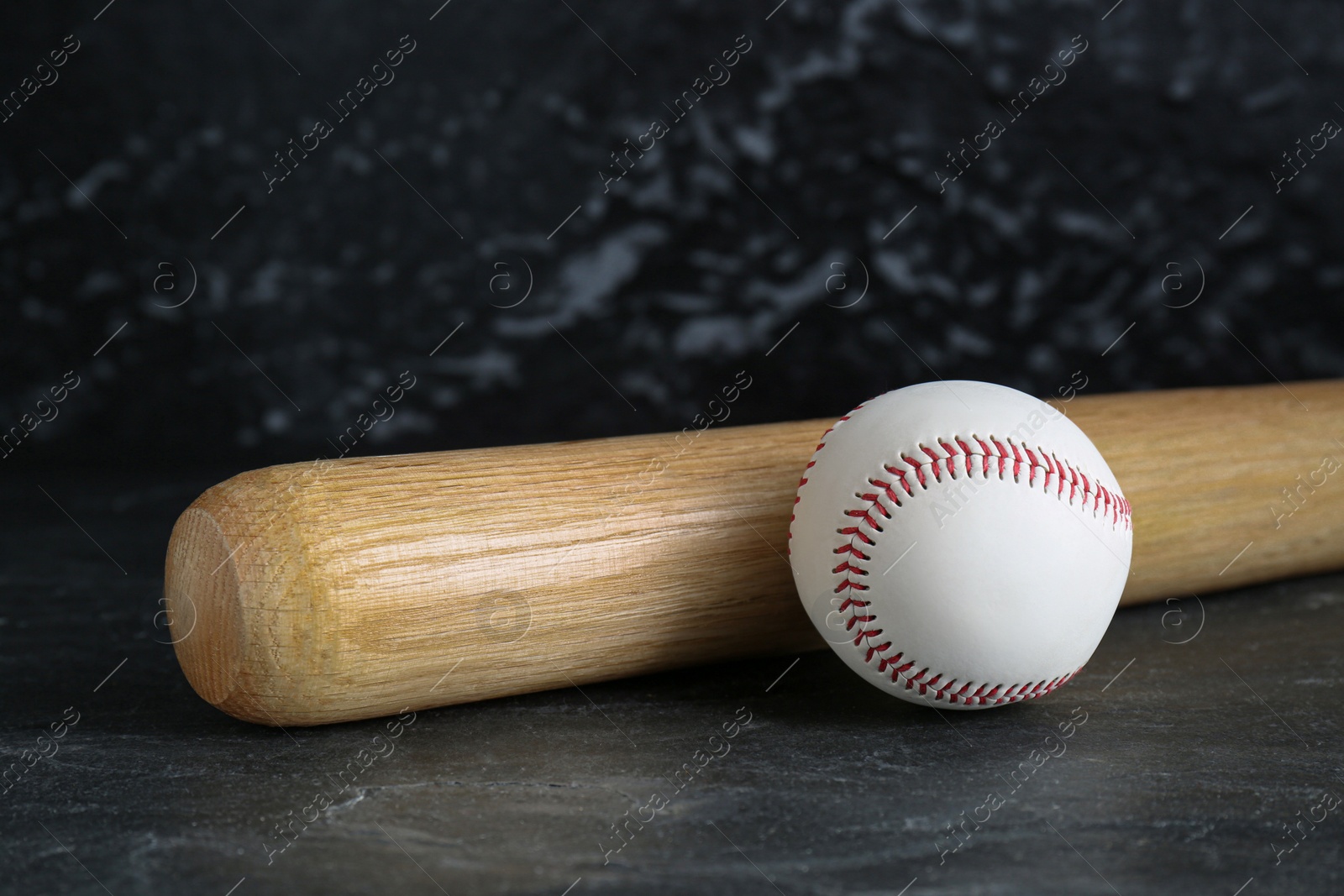 Photo of Baseball bat and ball on black background. Sports equipment