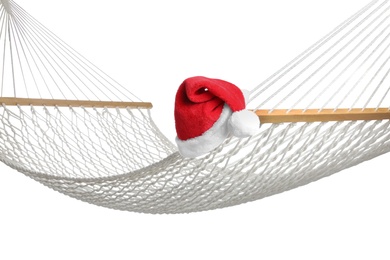 Comfortable hammock and Santa Claus hat on white background. Christmas vacation