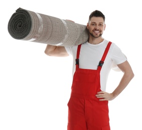 Photo of Male worker with rolled carpet on white background