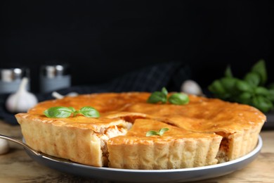 Photo of Delicious meat pie with basil on table, closeup. Space for text