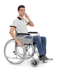 Photo of Young man in wheelchair talking by mobile phone isolated on white