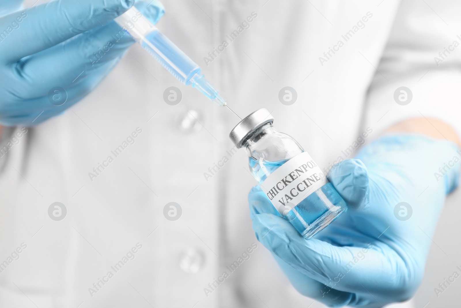 Photo of Doctor filling syringe with chickenpox vaccine, closeup. Varicella virus prevention