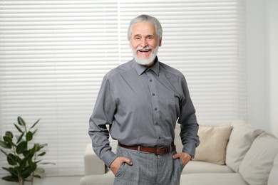 Portrait of handsome senior man at home