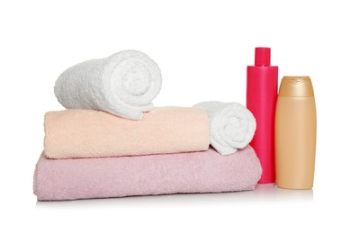 Photo of Soft terry towels and cosmetic products on white background