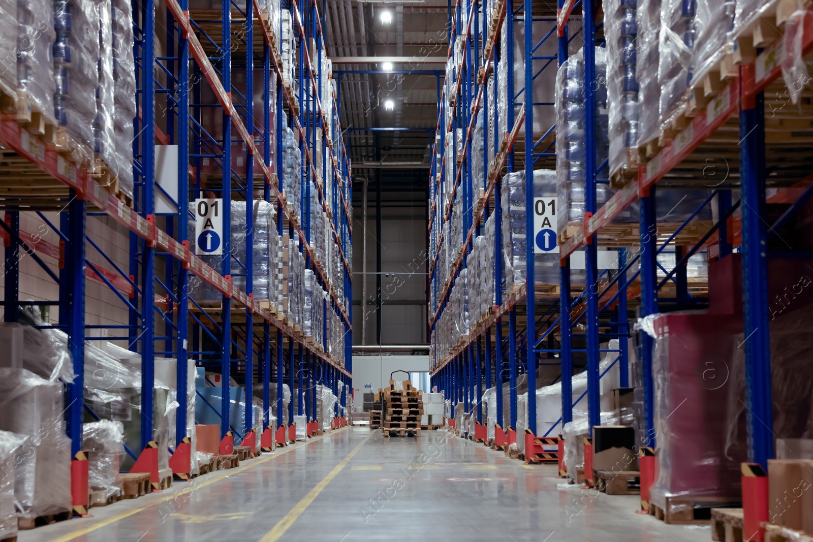 Photo of Warehouse interior with metal racks full of merchandise. Wholesale business