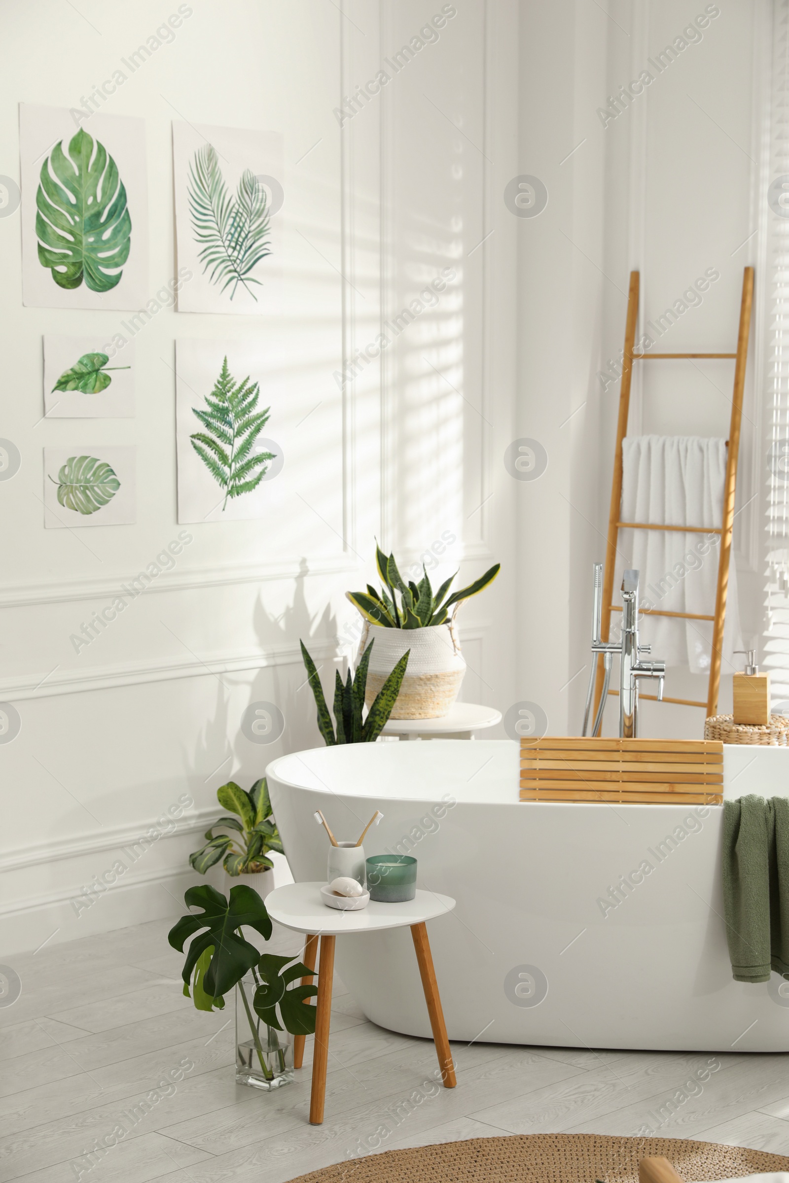 Photo of Stylish bathroom interior with green plants. Home design