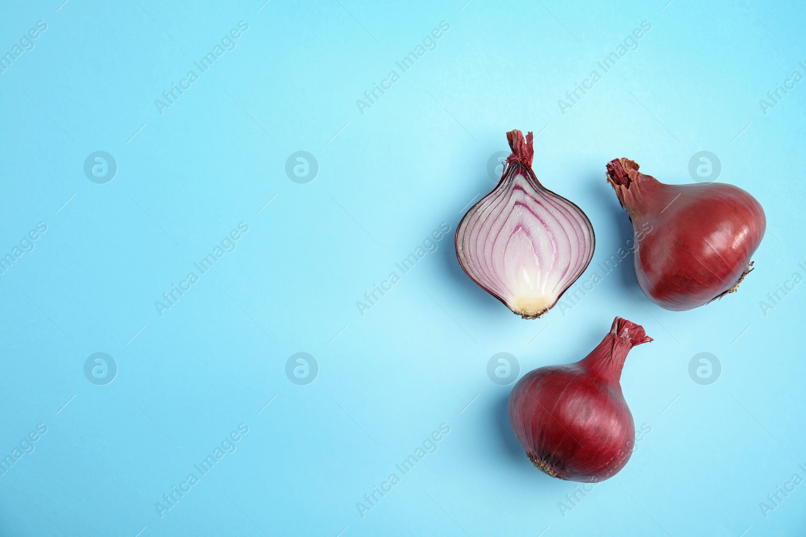 Photo of Beautiful composition with ripe red onions on color background