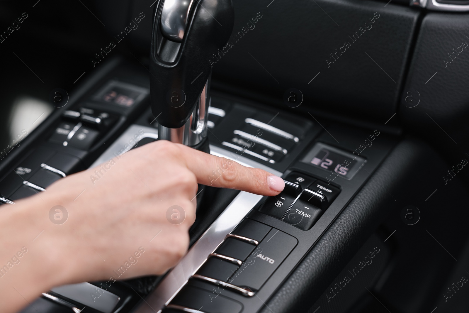 Photo of Woman using dashboard while driving her car, closeup