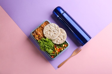 Thermos, lunch box with food on color background, flat lay