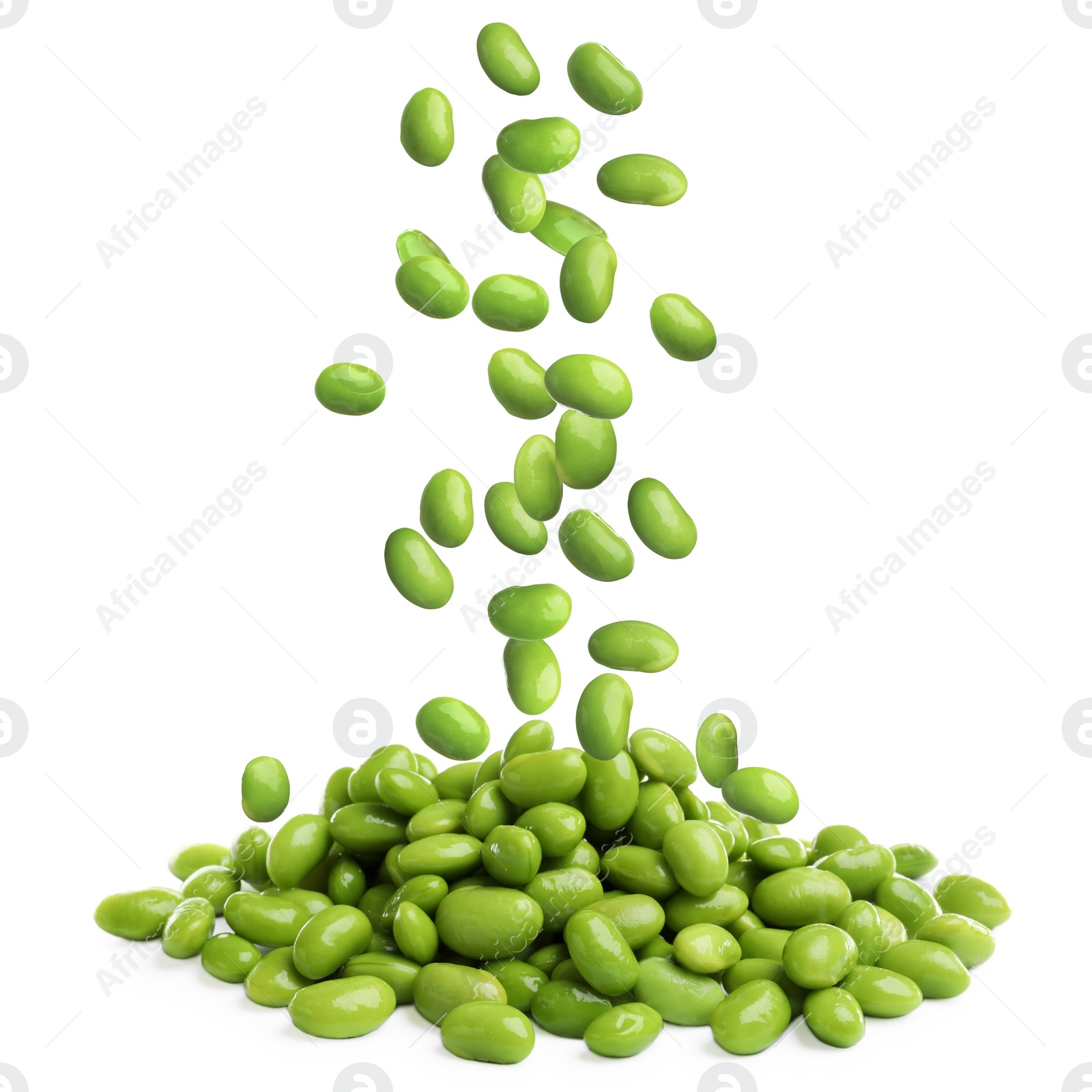 Image of Delicious edamame soybeans falling onto pile against white background