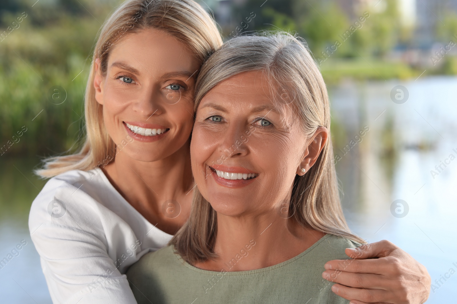 Photo of Family portrait of happy mother and daughter outdoors