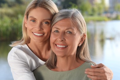 Family portrait of happy mother and daughter outdoors