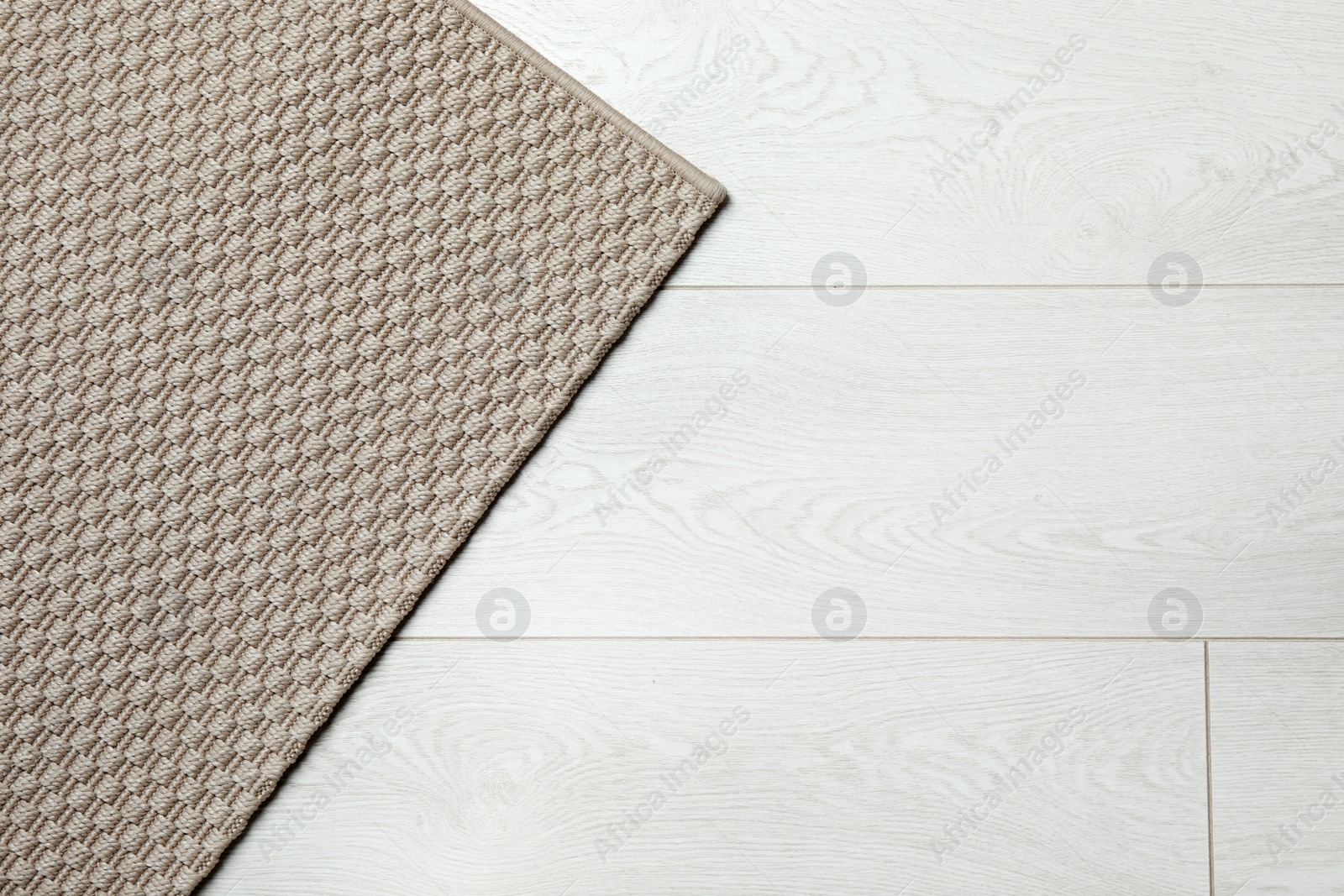 Photo of Woven mat on wooden background, top view with space for text