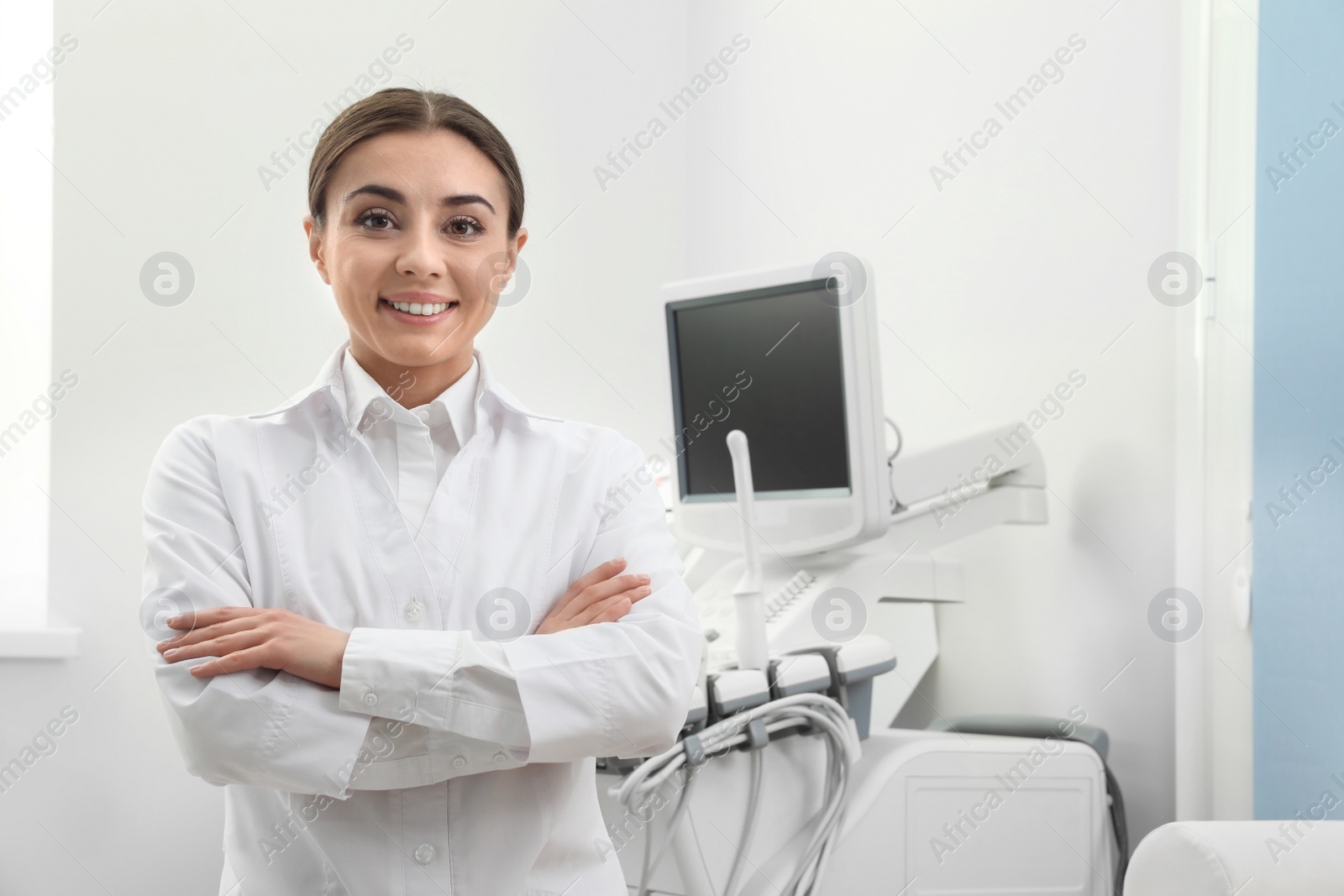 Photo of Professional sonographer near modern ultrasound machine in clinic