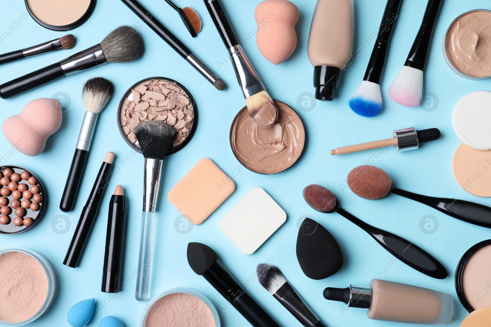 Photo of Flat lay composition with skin foundation, powder and beauty accessories on color background