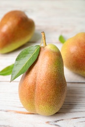 Photo of Ripe juicy pears on white wooden table