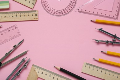 Flat lay composition with different rulers and stationery on pink background. Space for text