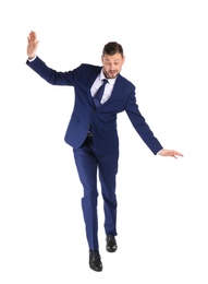 Full length portrait of businessman balancing on white background