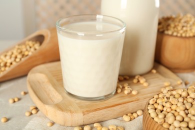 Fresh soy milk and beans on light grey table