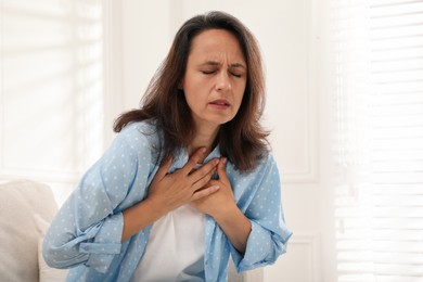 Photo of Mature woman suffering from breathing problem at home