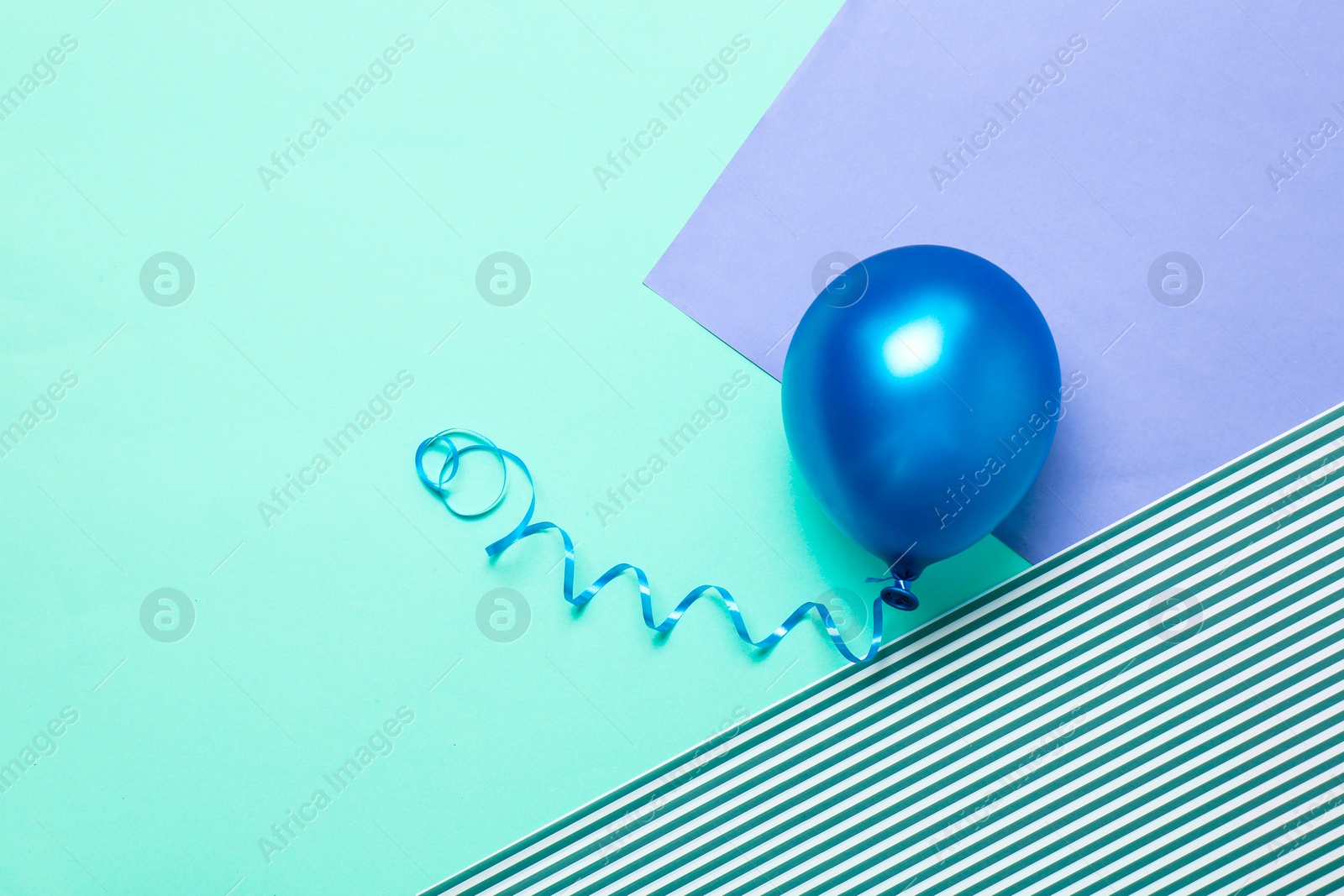 Photo of Bright air balloon on color background. Festive decor